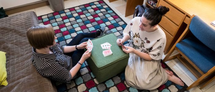 Students playing cards in a Harmon double room.